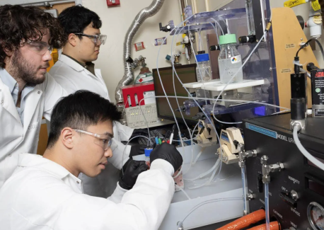 A new electrochemical reactor design developed with Marta Hatzell by postdoctoral scholar Hakhyeon Song (middle) and Ph.D. students Carlos Fernández and Po-Wei Huang (seated) converts carbon dioxide removed from the air into useful raw material. 