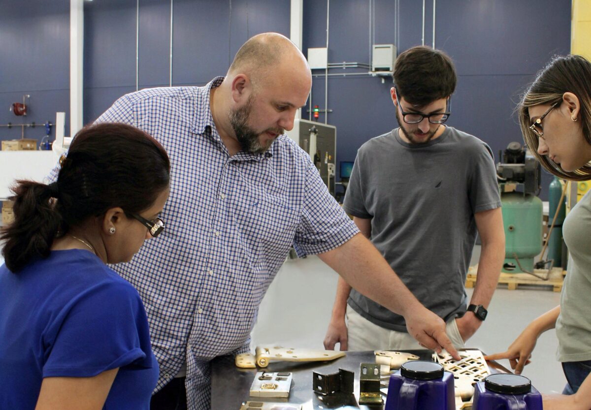 Aaron Stebner (second from left), associate professor in the College of Engineering, leads a lab session with students in the Delta Air Lines Advanced Manufacturing Pilot Facility at Georgia Tech. (Photo: Christa M. Ernst)