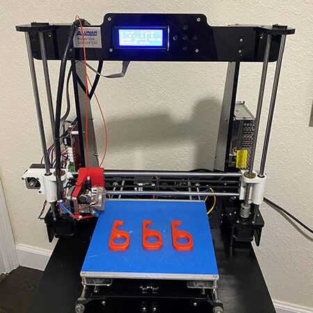 Kian Zarbaf's 3D printer and no-touch door openers on display. 