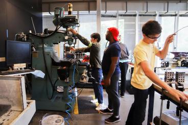 Three students working in the invention studio